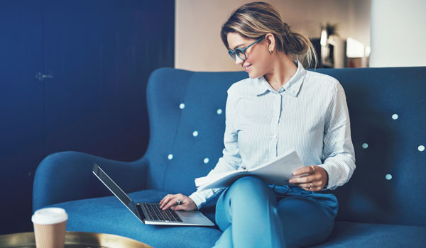 Woman reading about environmental sensors on a laptop