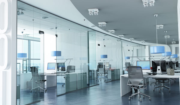 Hallway of a modern workplace with all-glass offices.